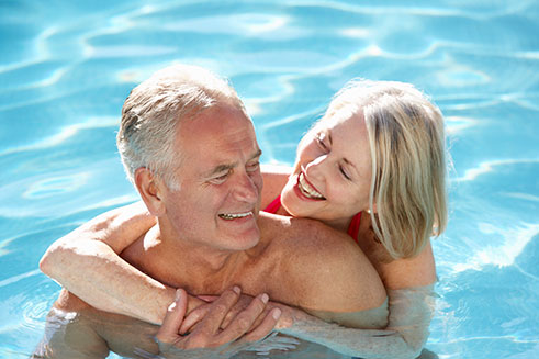 Couple swimming in solar heated pool
